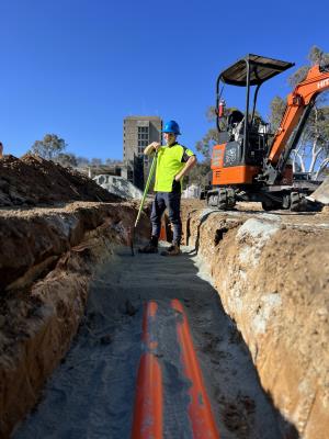 You man working on construction site laying electrical pipes